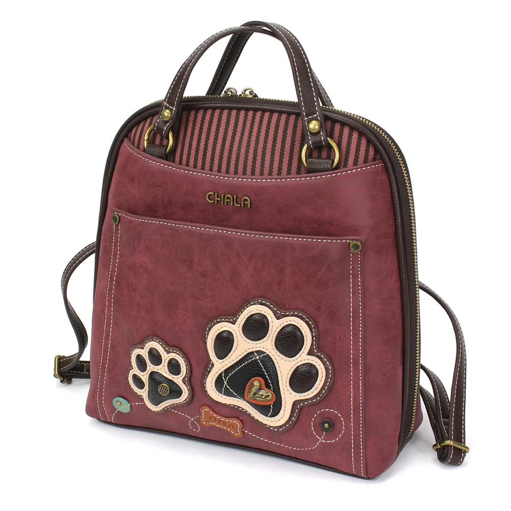 Elevate your style with the delightful Chala vegan leather convertible backpack purse, featuring a pawprint Chala Pal companion on the front. Crafted with cruelty-free materials, this charming accessory blends fashion with personality, making a statement that is both playful and environmentally conscious. Experience the perfect blend of whimsy and elegance with every wear, showcasing your unique flair wherever you go