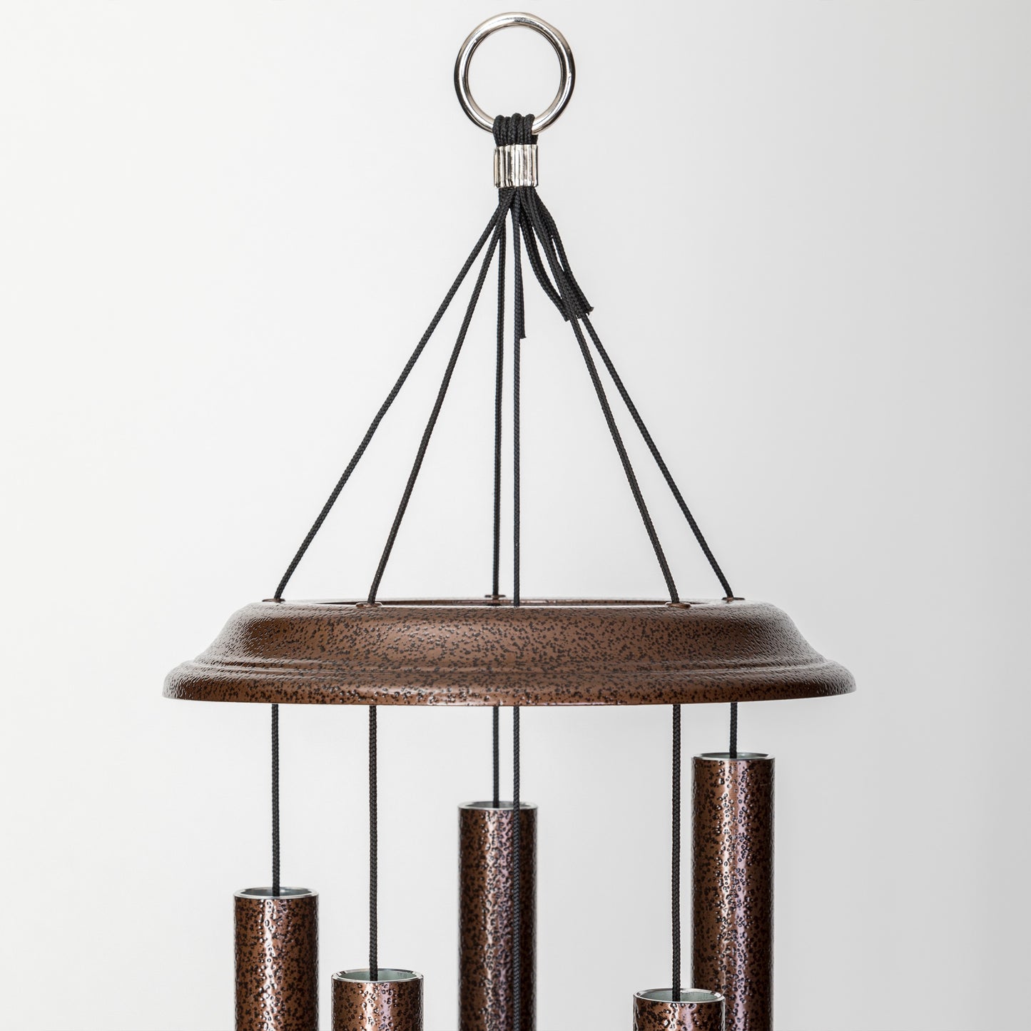 These Copper Vein Wind River Shenandoah Melodies wind chimes from Home and Garden Treasures are crafted with six hollow tubes of varying sizes suspended from a central ring, creating enchanting melodies as they dance in the breeze. Complete with a stylish round metal sail that catches gentle winds, each Shenandoah Melodies exemplifies the calming song of the Virginia countryside. Elevate your garden retreat with the perfect gift today!