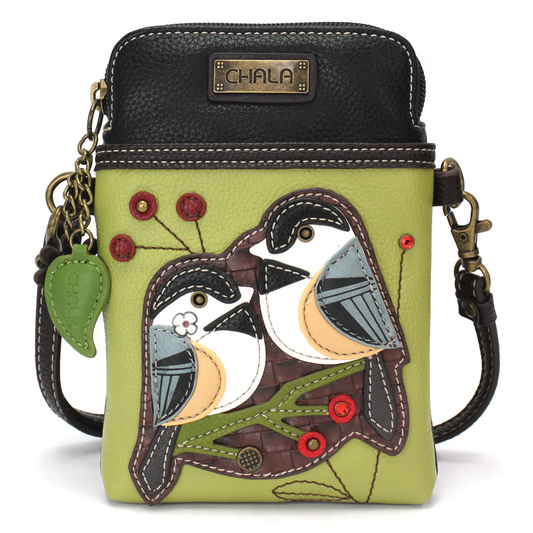 Elevate your style with the delightful Chala vegan leather crossbody handbag, featuring a whimsical Chickadee Chala Pal companion on the front. Crafted with cruelty-free materials, this charming accessory blends fashion with personality, making a statement that is both playful and environmentally conscious. Experience the perfect blend of whimsy and elegance with every wear, showcasing your unique flair wherever you go.