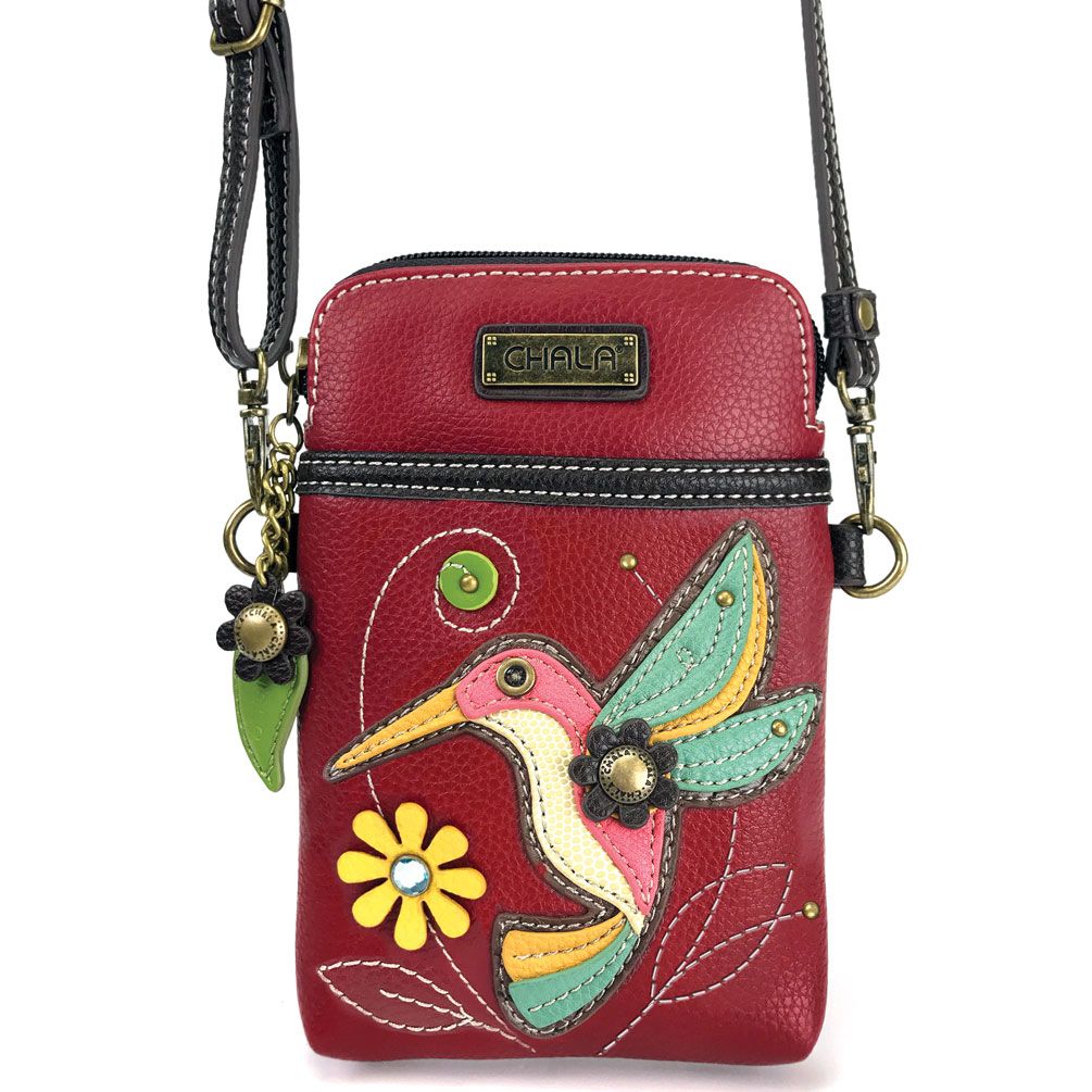 Elevate your style with the delightful Chala vegan leather crossbody handbag, featuring a whimsical Hummingbird Chala Pal companion on the front. Crafted with cruelty-free materials, this charming accessory blends fashion with personality, making a statement that is both playful and environmentally conscious. Experience the perfect blend of whimsy and elegance with every wear, showcasing your unique flair wherever you go.