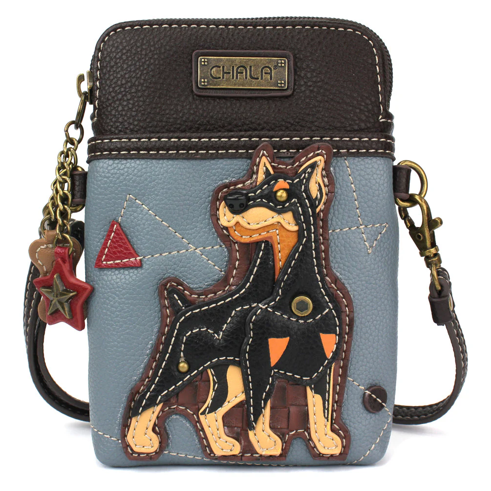 Elevate your style with the delightful Chala vegan leather crossbody handbag, featuring a whimsical Doberman Chala Pal companion on the front. Crafted with cruelty-free materials, this charming accessory blends fashion with personality, making a statement that is both playful and environmentally conscious. Experience the perfect blend of whimsy and elegance with every wear, showcasing your unique flair wherever you go.