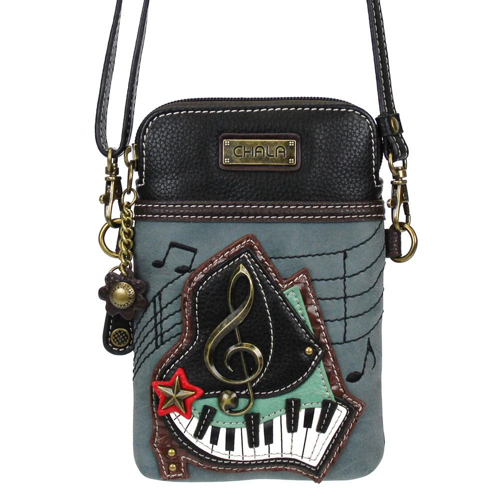 Elevate your style with the delightful Chala vegan leather crossbody handbag, featuring a whimsical Piano Chala Pal companion on the front. Crafted with cruelty-free materials, this charming accessory blends fashion with personality, making a statement that is both playful and environmentally conscious. Experience the perfect blend of whimsy and elegance with every wear, showcasing your unique flair wherever you go.